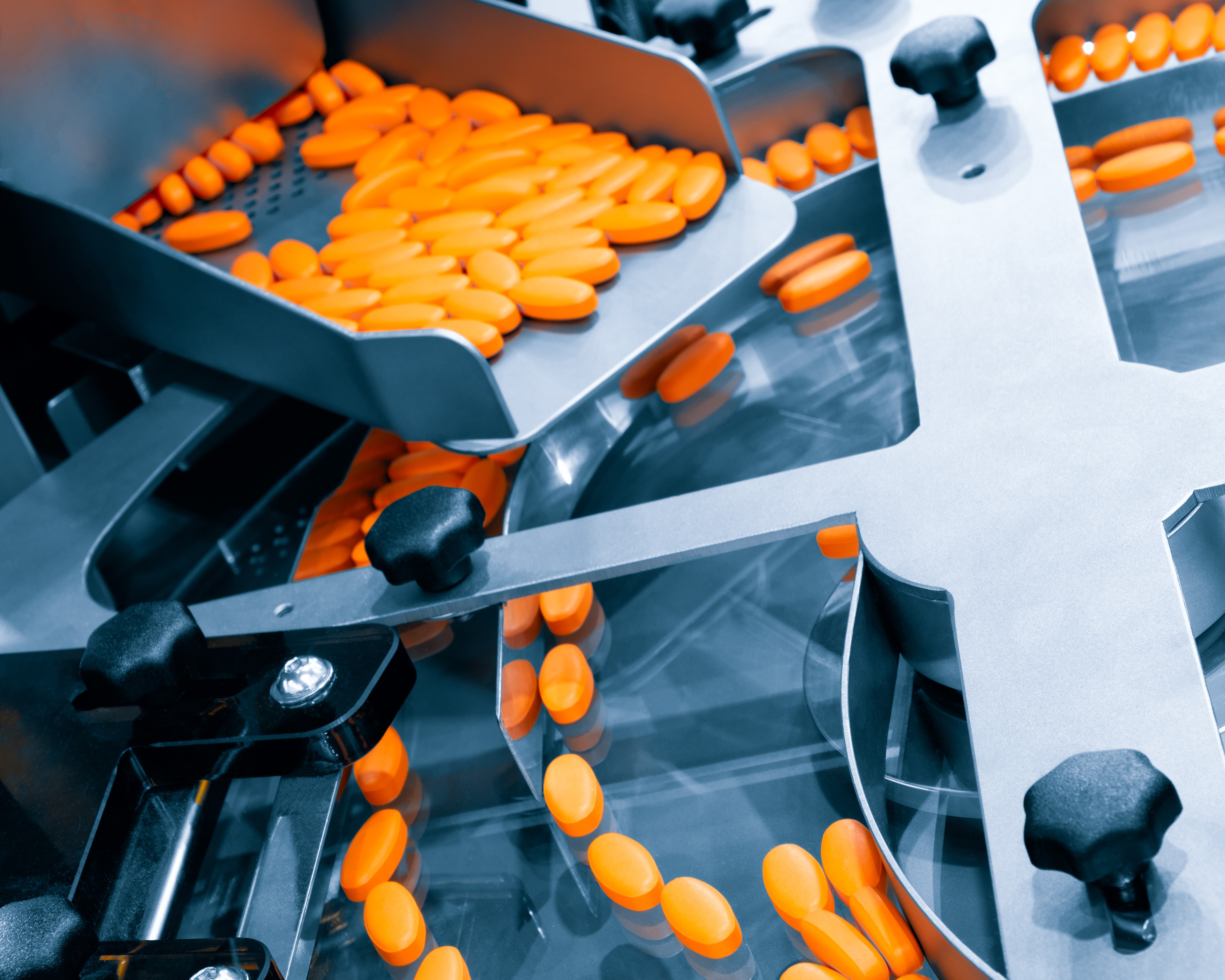Medicinal tablets funneled into a spinning filter.
